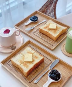 two trays with slices of toast and jam on them next to a cup of coffee