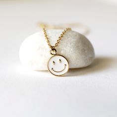 "Beautiful and lovely tiny happy face charm necklace. Made of white enamel gold smiley face charm with skinny gold plated brass chain. Soft and warm. Great for gift , everyday or special occasion. Your item will ship in a gift box. Please feel free to contact me if you have any question. ♥ Length 14\" -20\" chain ♥ Charm 3/8\" ♥ Gold plated over brass / white enamel ♥ Delivery Time Fast shipping within 1 - 3 days ♥ See more Rudiana Accessories Rudiana.etsy.com" Cute White Nickel Free Necklaces, Cute White Nickel-free Necklaces, Cute White Charm Necklace With Adjustable Chain, Cute White Nickel-free Charm Necklaces, Everyday White Charm Necklace In 14k Gold Filled, Everyday White 14k Gold Filled Charm Necklaces, Cute Everyday White Necklace, Cute White Everyday Necklace, Dainty White Necklace For Best Friend Gift