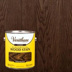 a can of wood stain sitting on top of a wooden floor next to a wall