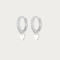 The Silver Gabby Heart Huggies are darling earrings crafted in sterling silver, featuring endearing heart-shaped accents in a classic huggie style. These earrings exude a timeless elegance with a touch of playful charm. Their sleek silver design makes them versatile, ideal for both casual and formal occasions, adding a delightful hint of love and sophistication to any ensemble. Available in various colours Hoop Size: 13mmx13mm Charm Size: 5mmx5mm Silver Plated Tarnish free / Water resistant 💧 Silver Sterling Heart Charm Huggie Earrings, Silver Sterling Huggie Earrings With Heart Charm, Elegant Sterling Silver Huggie Earrings With Heart Charm, Silver Heart Charm Huggie Earrings, Silver Huggie Earrings With Heart Charm, Silver Huggie Heart Charm Earrings, Silver Huggie Jewelry With Heart Charm, Silver Huggie Earrings With Heart Charm For Anniversary, Silver Elegant Huggie Earrings With Heart Charm