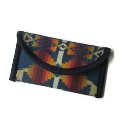 This is a clutch style wallet. There is 3 pockets for id's and charge cards on one side. The other side has a long open pocket for dollar bills. There is plenty of room to put your checkbook in between or even your cell phone. I used a quality magnetic snap as a closure to keep everything safe inside. Pendleton calls this wool "Siskiyou". The outside measurements of the wallet are about 8.5" x 4.5". Genuine Pendleton® wool is my fabric choice for all my wool items.  To go back to my main page cl Rectangular Coin Purse With Pockets For Travel, Rectangular Travel Coin Purse With Pockets, Vintage Trifold Wallet With Coin Pocket For Travel, Vintage Trifold Wallet With Rfid Blocking For Travel, Travel Trifold Wallet With Pockets, Travel Trifold Wallet With Coin Pocket, Retro Rectangular Travel Wallet, Vintage Multicolor Travel Wallets, Pendleton Blanket