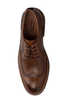 Herringbone pattern woven details meet a wingtip toe silhouette to create this unique lace-up. Round wingtip toe Broguing details Woven texture details Lace-up Leather upper, manmade sole Imported Vintage Brown Lace-up Business Shoes, Brown Wingtip Oxfords With Laces, Vintage Lace-up Shoes With Brogue Detailing And Pointed Toe, Wingtip Oxfords With Laces, Vintage Wingtip Oxfords With Laces, Vintage Brown Lace-up Shoes With Brogue Detailing, Vintage Brown Lace-up Shoes For Business, Vintage Wingtip Lace-up Shoes For Derby, Vintage Oxfords For Formal Occasions