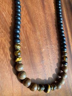 This stunning beaded necklace features an array of Tiger's Eye stones that are sure to turn heads. The warm, earthy tones of the stones are complemented by the delicate beads that make up the chain. The necklace is perfect for dressing up any outfit and is versatile enough to be worn to work or out on the town. Each stone is unique, making this necklace a one-of-a-kind piece. The necklace is made of high-quality materials, ensuring that it will last for years to come. Brown Beaded Chain Bracelets For Jewelry Making, Earthy Gemstone Beads Necklaces For Healing, Adjustable Spiritual Beaded Necklaces, Brown Beaded Chain Jewelry For Gifts, Brown Beaded Chain Jewelry As Gift, Brown Beaded Chain Jewelry Gift, Adjustable Brown Beaded Necklaces, Gift Brown Beaded Chain Jewelry, Adjustable Long Beaded Necklace With Natural Stones