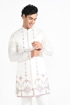 Ivory Phulkari inspired Nehru Jacket with pipe, cutdaana and thread work embroidery with same coloured kurta with embroidery detail on the chest and sleeve. this set in made in linen Satin, Paired with Ivory slim fit Pant Pajama. Color of
the actual garment may vary due to lighting conditions during the shoot.

Size Chart For Men





	
	
					Men's Size Chart
		

		
		
						
				Size Chart For Men
				Custom Size Measurement Guide
			
			
				
				
				Custom Size Measurement Guide
1. Take you Transitional Nehru Jacket With Zari Work For Traditional Ceremonies, Embroidered Off White Traditional Wear For Festivals, Off White Embroidered Traditional Wear For Festivals, Traditional Multicolor Embroidered Sherwani For Festive Occasions, Ceremonial Sherwani With Multicolor Embroidery For Eid, Bollywood Style Embroidered Nehru Jacket For Traditional Ceremonies, Traditional Off White Kurta For Transitional Season, Bandhgala With Multicolor Embroidery For Festivals, Traditional Off White Nehru Jacket For Eid