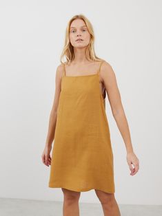 DEVON is a square neck strap mini linen dress which combines modern minimalism with a breathable fit, ideal for warm climates and summer events. Its sophisticated square neckline and a strap design make it versatile for both casual days and elegant evenings. DETAILS - Square neckline - Spaghetti straps - Mini length - 100% midweight European linen fabric - Cut and sewn to order just for you in our studio COLOR - Yellow Honey, you can also choose other colors above - Fabric samples are available Chic Linen Mini Dress With Square Neck, Casual Square Neck Slip Dress With Adjustable Straps, Casual Slip Dress With Square Neck And Adjustable Straps, Casual Slip Dress With Adjustable Straps And Square Neck, Cotton Sundress With Adjustable Straps And Straight Neckline, Summer Linen Sundress With Straight Neckline, Chic Square Neck Linen Beach Dress, Chic Unlined Linen Dress With Straight Neckline, Linen Mini Dress With Square Neck