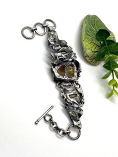 "Artisan Amber gemstone bracelet Hand-made Sterling Silver 925 Stones used: Baltic Amber, Abalone Shell, Pearls, Peridot, Amethyst Amber stone -Height - 30mm (with bail), Width - 22mm Length - 8 1/2 inches, good for 7 and 7 1/2 inches Heigh of bracelet - 1 3/8\" Unique Handcrafted One-of a-kind Design Bracelet Each Piece of Jewelry in my Collection is Absolutely One of a Kind! When you start wearing a piece of my jewelry you will fall in love with it more and more each day and feel that good Ene Handmade Metal Bracelet Jewelry, Spiritual Hand Cast Bracelet Jewelry, Spiritual Hand-cast Bracelet Jewelry, Spiritual Hand Cast Jewelry Bracelet, Fusion Style Bracelet Jewelry For Gifts, Fusion Style Bracelet Jewelry As Gift, Fusion Style Bracelet Jewelry Gift, Fusion Style Jewelry Bracelet For Gifts, Fusion Style Jewelry Bracelet Gift