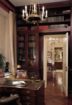 a room with a desk, chair and bookshelf