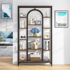 a living room with a book shelf and pictures on the wall