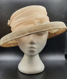 Vintage Fashion Hat Andre Canadian Hat Company Beige Lightweight Summer Ribbon I had the fortunate opportunity to go to an estate sale where the lady who lived there collected hats.  I have close to 100 hats; some are designer and some are handmade. This one comes with a hat box, 2001 Gabriela Ibarra Art in Motion. The entire hat measure 12 1/2" x 11 3/4" x 4 3/4" high.  The inner brim is 7" x 6 1/4".  The hat has more of a sheen to it like in the second photo. This hat is handmade in Canada. Ge Classic Church Hat Fascinator, Beige Brimmed Cloche Hat For Evening, Cream Cloche Hat For Evening, Gold Fedora Hat For Formal Occasions, Cream Brimmed Cloche Hat For Evening, Elegant Cream Fedora For Formal Occasions, Elegant Cream Hat Bands For Formal Occasions, Vintage Cream Fitted Fedora, Beige Cloche Hat For Church