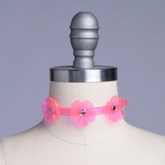 Delicate choker with a dimensional triple floral design in neon pink PVC. Collar is uv-reactive. Fit is adjustable with buckle in back. Collar is 1/2" wide. Silver toned nickel-coated hardware. SMALL/MEDIUM (11-13")MEDIUM/LARGE (13-15")LARGE/X-LARGE (15-17") Custom sizing available. All pieces are MADE TO ORDER. If your measurements fall outside these standards or you are unsure of what size to order, select "CUSTOM" and include your measurements in the notes upon checkout so we can adjust for a Costume Aesthetic, Daisy Choker, Video Game Costumes, Rose Choker, O Ring Choker, Delicate Choker, Blue Choker, Y2k Necklace, Fashion Boards