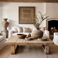 a living room filled with furniture and a fire place next to a wall mounted fireplace