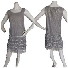 Be The Belle Of The Ball In This Stunning Silver Flapper Dress From Max Studio Specialty Products. This Knee-Length Sheath Dress Features A Beautiful Batik Pattern, Boat Neck Neckline, And Sleeveless Design. The Dress Is Made From A Luxurious Microfiber Fabric That Contains Polyester, Spandex, And Polyester Blend Materials. The Dress Features Eye-Catching Accents Such As Fringes, Beads, And Sequins That Add To Its Overall Glamour. The Dress Is Perfect For Any Formal Occasion Such As Weddings, Pa Sleeveless Sequined Flapper Dress For Summer, Sleeveless Sequined Summer Flapper Dress, Fitted Sleeveless Flapper Dress For Summer, Sequin Sleeveless Fitted Flapper Dress, Sleeveless Sequined Fitted Flapper Dress, Fitted Sleeveless Sequin Flapper Dress, Spring Sleeveless Flapper Dress, Elegant Sleeveless Spring Flapper Dress, Silver Flapper Dress