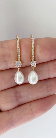 Our pearl drop bridal earrings are simply stunning! A simple classic earring. Little bit of bling, classic pearl, small drop... perfect combo! These long pearl drop earrings catch the light, packing serious sparkle for their size. Combining marquise crystals stones they're finished with glowing pearls. With just the right amount of sparkle, this dainty pair is perfect for brides, mother of the bride and bridesmaids alike. -Drop Pearls are light ivory- These Crystal and pearl wedding earrings will add a flawless finish to every bridal look. ** Delivery is 3 Weeks ** SHOP MORE STYLES https://www.etsy.com/ie/shop/BridalStar?ref=related&listing_id=768478002# *RETURNS- We accept returns . ** Bridal Jewelry Pearl Earrings, Diamond And Pearl Earrings, Bridal Jewelry Gold, Brides Mother, Bridal Jewelry Pearl, Elegant Pearl Jewelry, Jewelry Pearl Earrings, Bridal Drop Earrings, Gold Bridesmaid Jewelry