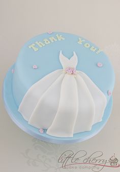 a blue and white cake with a dress on it