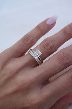 a woman's hand with a diamond ring on it