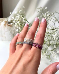 "Discover the beauty and versatility of our elastic gemstone rings, now available on ROMANIV Jewelry! My collection features a stunning array of natural gemstones including Super Seven, Emerald, Moonstone, Aquamarine, Italian Coral, Iolite, Burma Jade, Garnet, Zircon, Ruby, and Spinel. Each ring is carefully crafted with high-quality materials and designed to provide comfort and style for everyday wear. Elastic design ensures a perfect fit for any finger size making them an ideal gift for yourse Dainty Inelastic Stackable Jewelry, Dainty Stackable Jewelry, Adjustable Moonstone Ring For Everyday, Adjustable Everyday Moonstone Ring, Adjustable Sterling Silver Stackable Rings With Natural Stones, Adjustable Stackable Moonstone Ring Spiritual, Adjustable Stackable Spiritual Moonstone Ring, Spiritual Birthstone Rings, Dainty Rondelle Gemstone Beads Jewelry