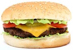 a cheeseburger with lettuce, tomato and pickle on it's bun