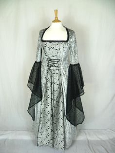 This listing is for a custom made dress,it will be made to the measurements you send me. Please send me a message with your bust ,waist and hip measurements,and please measure from the top of your shoulder to the floor with shoes on. It will be made with beautiful silver grey crushed velvet and stunning grey and black silk fabric. The sleeves are part velvet with a stunning black embroidered organza .It has a corset style front and back with lacing so you can adjust the dress to fit your body sh Black A-line Wedding Gown, Black Wedding Gown With Boned Bodice, Floor-length Black Corset Dress For Wedding, Black Gown With Fitted Bodice, Black Fitted A-line Gown, Fitted Black A-line Gown, Gothic Ball Gown For Wedding, Elegant Wedding Corset Dress For Halloween, Black Ball Gown With Boned Bodice