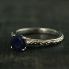 "Lapis Lazuli Ring Full Cut Lapis Ring Blue Engagement Ring Antique Style Ring Sterling Silver Alternative Engagement Ring Blue Jeans Looking for your bride's \"something blue\"? Look no further than our Lapis Lazuli solitaire \"Blue Jeans\" ring. This traditional setting is modernized with a full cut 6mm Lapis Lazuli stone. Its name comes from the Latin lapis, \"stone,\" and the Persian lazhuward, \"blue.\" It is said to help bring inner peace and clear one's mind from negative thought patterns Sapphire Diamond Cut Promise Ring Jewelry, Elegant Blue Stackable Jewelry, Classic Royal Blue Round Sapphire Ring, Blue Rings With Prong Setting For Promise, Blue Fine Jewelry Stackable Promise Rings, Blue Round Band Jewelry For Promise, Blue Round Band Promise Jewelry, Blue Fine Jewelry Stackable Rings For Promise, Blue Stackable Rings For Promise In Fine Jewelry Style