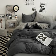 a bed room with a neatly made bed and black and white checkered flooring