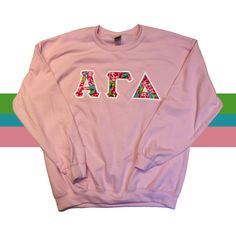 Pink Crew Sweatshirt With Embroidered Graphics, Pink Crew Neck Sweatshirt With Letter Print, Pink Long Sleeve Top With Letter Embroidery, Long Sleeve Pink Top With Embroidered Text, Pink Crew Neck Top With Letter Print, Pink Crew Neck Sweater With Embroidered Text, Pink Long Sleeve Sweatshirt With Embroidered Text, Pink Tops With Embroidered Text For Winter, Pink Cotton Sweatshirt With Embroidered Graphics