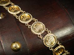 "This exquisite vintage bracelet comes with an appraisal card from North American Gem Lab of Bellevue Washington appraising for $2,700.00. It features 10 Saint-Gaudens double eagle replica coins dated 1914. This bracelet is in excellent condition! The bracelet is hallmarked 14k and measures 13mm wide by 7\" long. Items $100 or more are shipped in a velvet gift box. Items less then $100 will be shipped in a cardboard box with tissue and a fabric ribbon, ready for gift giving or just for safekeepi Antique 14k Stamped Gold Bracelet, Antique Gold Bracelet Stamped 14k, Antique Ceremonial Gold Jubilee Bracelet, Antique Yellow Gold Collectible Bracelets, Collectible Yellow Gold Bracelet, Collectible Victorian Gold Jubilee Bracelet, Victorian Gold Hallmarked Bracelet, Formal Antique Gold Jewelry Stamped 14k, Gold Collectible Bracelet