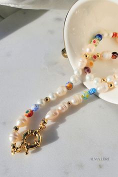 This beautiful Pearl & Millefiori Necklace is the most trendy, affordable and high-quality handmade piece you ever have, is made of Freshwater Pearls, and glass millefiori beads, each necklace is beaded in a unique pattern, which means each necklace is different from others, this delicate design makes it perfect for an effortless look 💕 Multicolor Pearl Charm Jewelry As Gift, Multicolor Pearl Charm Jewelry Gift, Multicolor Jewelry With Pearl Charm For Gift, Multicolor Jewelry With Pearl Charm As Gift, Colorful Beads Pearl Necklace Gift, Colorful Beaded Round Pearl Necklace Gift, Colorful Beaded Round Pearl Necklace For Gift, Colorful Beaded Pearl Necklace Gift, Flower Shaped Single Strand Beaded Necklace For Gift