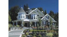 a large house with lots of windows and landscaping