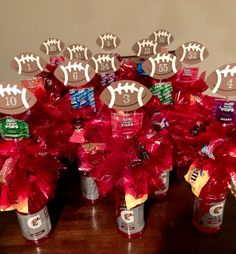 a table topped with red pom poms and football decorations