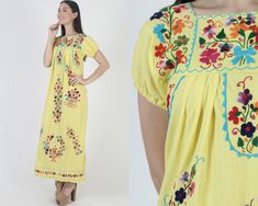 Vintage traditional Mexican Puebla maxi dress. Tailored chest with puffed cap sleeves.  Gathered and draped trapeze shift fit. Yellow soft cotton with bright floral hand embroidery. size estimate: S/M shoulders: 16" bust: 36" waist: 47" hips: 48" total length: 52.5" * Visit the shop * https://www.etsy.com/shop/americanarchive Model is 5'9" and measures 32" bust, 25" waist, 35.5" hips. Belts/accessories are not included unless noted in the description. Cotton Maxi Dress With Floral Embroidery And Short Sleeves, Spring Embroidered Yellow Maxi Dress, Yellow Folk Dress For Spring, Spring Yellow Embroidered Maxi Dress, Multicolor Spring Maxi Dress For Fiesta, Multicolor Maxi Dress For Spring Fiesta, Spring Fiesta Multicolor Maxi Dress, Short Sleeve Multicolor Embroidered Maxi Dress, Traditional Short Sleeve Maxi Dress For Spring