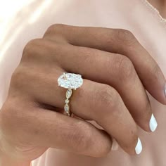 a woman's hand with a diamond ring on it