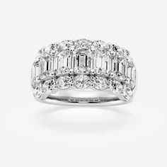 a white gold ring with baguetts and diamonds on top, set in 18k white gold