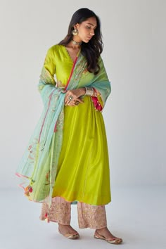 Bright green kurta with kalis on the sides and placement embroidery. Comes with nude pink palazzo and dreamy blue dupatta.
Components:3
Pattern:Embroidery
Type of Work:Sequin, Beads, Cutdana, Thread and Pearl
Neckline:V neck
Sleeve Length:Three Quarter
Fabric:Silk, Modal Satin and Organza
Color:Green
Other Details:
Sleeves with bead drops
Dupatta with embroidery and tassels at the ends
Embroidered palazzo hems
Occasion:Puja - Aza Fashions Maharani Designer Boutique, Blue Dupatta, Placement Embroidery, Bollywood Dress, Salwar Kamiz, Palazzo Set, Designer Kurtis, Silk Kurta, Punjabi Salwar Suits