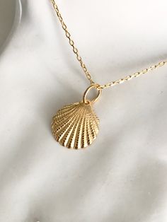 Our Tiny Seashell necklace is a symbol of protection. This little treasure is a reminder of the magic of the ocean and the peace of the beach. Perfect for layering or wear alone for a classic minimal look. With such deep meaning this necklace makes the perfect gift for loved ones for a number of occasions, ready to be worn and cherished for years to come.  Size - Pendant: cm / Chain: 18 Inch (45 cm) The necklace is made from 18k Gold Plated 925 Sterling Silver. With its small size the shell is extremely detailed, making for a very special piece. With the proper care the piece will last and retain its colour. Care instructions are provided with the jewellery.  If you have any questions, please do not hesitate to contact me. Gold Seashell Necklace, Savannah Style, Dainty Jewellery, Silver Mermaid, Seashell Necklace, Sister Wife, Deep Meaning, Wife Gift, Layering Necklace