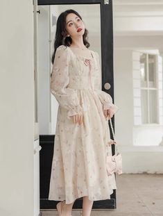 Lightweight silky chiffon printed midi dress with a square neckline, long sheer puff sleeves, tie-up lace neck and laced waistline. Concealed back zipper. Lined. S: 33" chest, 26.5" waist, 43" lengthM: 34.5" chest, 28" waist, 43" lengthL: 36" chest, 29.5" waist, 43.5" lengthXL: 37.5" chest, 31" waist, 43.5" length Chic Midi Dress With Lace Trim And Square Neck, Chic Lace Midi Dress With Square Neck, Chiffon Midi Dress With Long Sleeves For Daywear, Chiffon Long Sleeve Midi Dress For Daywear, Feminine Long Sleeve Chiffon Midi Dress, Beige Lantern Sleeve Dress For Spring, Feminine Cream Midi Dress With Square Neck, Feminine Cream Square Neck Midi Dress, Cream Lantern Sleeve Dresses For Spring