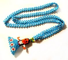 a blue beaded necklace on a white surface