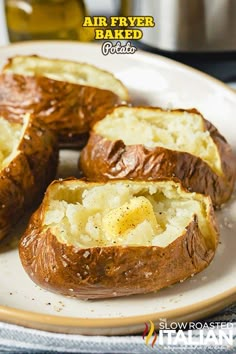 baked potatoes on a plate with oil in the background and text overlay that reads air fryer baked potato