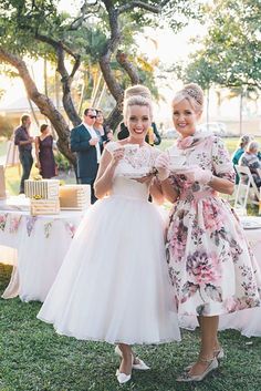 two women standing next to each other at a wedding