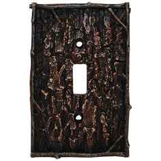 an iron switch plate cover with tree bark