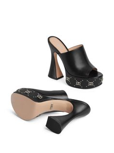 GG 115mm platform mules from Gucci featuring black, leather, silver-tone stud detailing, open toe, slip-on style, branded insole, platform sole and high block heel. This item is in size 36 and the color is Black Gucci Luxury Round Toe Slides, Gucci Luxury Open Heel Mules, Gucci Low Heel Luxury Heels, Luxury Gucci Round Toe Slides, Luxury Gucci Mules With Leather Sole, Gucci Designer Luxury Mules, Luxury Gucci Patent Leather Heels, Luxury Gucci Open Heel Mules, Gucci Luxury Dress Shoes With Round Toe