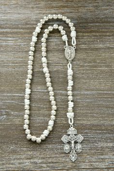 Elevate your spiritual connection with the "Divine Elegance" Paracord Rosary, a perfect blend of strength and grace. This exquisite rosary is a testament to the enduring faith within you, meticulously handcrafted with 10mm alloy metal beads that radiate elegance and durability. As each bead shines brilliantly in the light, "Divine Elegance" exudes a timeless charm that's reminiscent of a heavenly gift. Drenched in purity and symbolism, this rosary boasts all-silver colored beads, elegantly paire Silver Rosary With Faceted Beads, Nickel-free Silver Cross Rosary, Silver Faceted Beads Rosary Cross, Paracord Rosary, Military Rosary, Bohemian Hand-strung Rosary With Round Beads, Gift From Heaven, Miraculous Medal, Rosary