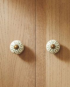 two wooden cupboards with knobs on them