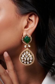 Indulge in sophistication with these Kundan earrings, featuring a striking emerald stone surrounded by sparkling diamonds, exuding timeless elegance and charm. Finish: 22KT Gold Plating Material: Brass, Kundan, Carved Emerald Stone Color: Gold, Green Size: One Size Closure Type: Push Back Box Contains: 1 Pair of Earrings Carved Emerald, Hand Jewelry Rings, Chain Braid, Kundan Earrings, Emerald Stone, Hand Jewelry, Anklet Jewelry, Charm Gift, Sparkle Diamonds