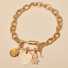 Level up your bracelet game with our Personalized Lucky Charm Bracelet, a chunky chain with added meaning. This bracelet features a screw clasp oval locket, ready to fill with precious charms and dedications of love. Mix and match between discs, letters and birthstones to create a one-of-a-kind personalized bracelet that shines just as uniquely as you do.&nbsp;18K Champagne Gold PlatedMini Flat Disc: 1x1cmSmall Flat Disc: 1.5x1.5cmMedium Flat Disc: 1.9x1.9cmMini Disc, Mini Star, Mini Heart, Bracelet Game, Lucky Charm Bracelet, Alphabet Charm, Oval Locket, Personalized Bracelet, Mini Charm, Grandmother Gifts, Pearl Collection, Classy Jewelry