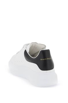 Alexander McQueen smooth leather sneakers with oversize rubber sole. Leather lining, removable insole, contrasting heel tab, polished metal eyelets, gold-printed logo on the tongue and back, perforated sides. Extra laces included. Size Info IT Color Detail White Made In Italia Material 100% calfskin Season One spring Season Two summer Product shoes Brand Alexander Mcqueen Size And Fit Heel Height = 4 cm Luxury Sneakers With Perforated Toe Box For Streetwear, Luxury Perforated Sneakers For Streetwear, Luxury Streetwear Sneakers With Abzorb Midsole, Designer Streetwear Sneakers With Perforated Toe Box, Luxury High-top Sneakers With Perforations For Streetwear, Luxury High-top Sneakers With Contrast Sole For Streetwear, Designer Platform Sneakers For Streetwear, Luxury Sneakers With Perforations And White Sole, Luxury Low-top Sneakers With Perforations