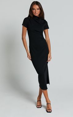 Get ready to turn heads in the Zayna Midi Dress! This black jersey dress is a basic wardrobe staple that will take you from workwear to happy hour effortlessly. The short sleeves add a touch of femininity, while the midi length keeps it classy and sophisticated. Made with soft and stretchy cotton jersey, this dress offers all-day comfort without compromising on style. Whether you're dressing it up with heels or keeping it casual with sneakers, the Zayna Midi Dress is sure to become your new go-t Sleek Midi Dress With Side Slits For Work, Short Sleeve Stretch Midi Dress, Stretch Elastane Midi Dress With Short Sleeves, Classic Bodycon Short Sleeve Midi Dress, Classic Bodycon Midi Dress With Short Sleeves, Classic Stretch Short Sleeve Midi Dress, Workwear Midi Dress With Side Slits, Sleek Short Sleeve Midi Dress For Summer, Sleek Workwear Dresses With Side Slits