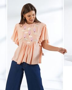 ▶ ABOUT THE TOP: This peach top is a statement of style. Hand embroidered with sequin and beads in shape of cute hot air balloons. Perfect for a day out at the office or a casual brunch with your friends. Made from georgette fabric, the top has a loose fit and we offer it in plus sizes up to 5XL. ▶ ITEM DETAILS: * Top made with georgette, medium weight, airy * The model is 5'7 tall and wearing size M. * Handmade item, crafted to perfection. * The length of the top is 19 inches ▶ FABRIC: * Made f Orange Embroidered Tops For Summer, Spring Embroidered Orange Blouse, Fitted Embellished Embroidered Top For Summer, Orange Short Sleeve Tops With Floral Embroidery, Orange Floral Embroidery Short Sleeve Tops, Orange Floral Embroidered Short Sleeve Tops, Feminine Pink Embroidered Summer Top, Feminine Pink Embroidered Top For Summer, Spring Embellished Short Sleeve Tops