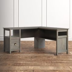 an office desk with two drawers on the bottom and one drawer in the middle, against a white wall