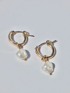 These classy and classic pearl hoop earrings are made using 14k gold fill, so they are safe for sensitive ears. -- Details -- 14k gold fill, pearl charm 12mm 14k gold fill hoops Each piece is handmade with love in my studio in sunny Marina Del Rey, CA. Everyday Small Hoop Jewelry With Pearl Charm, Gold Plated Small Hoop Pearl Charm Jewelry, Small Hoop Gold-plated Jewelry With Pearl Charm, 14k Gold-filled Huggie Hoop Earrings With Pearl Charm, Everyday Hoop Earrings With Pearl Charm, Gold Huggie Earrings With Pearl Charm, Handmade 14k Gold Filled Pearl Earrings For Everyday, 14k Gold-filled Pearl Drop Huggie Jewelry, 14k Gold Filled Pearl Drop Huggie Jewelry