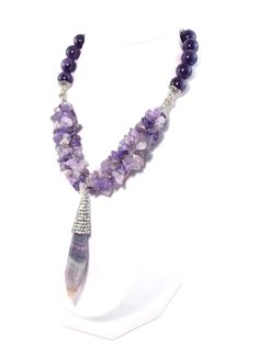 This stunning piece makes gorgeous statement! Semi precious Amethyst stones coupled with this beautiful semi precious crystal Fluorite pendant create an regal look with a rich luxurious feel! Silver plated accents add an elegant touch and help to complete the look! Necklace also includes extender chain so as to adjust Luxury Amethyst Pendant Jewelry, Luxury Amethyst Jewel Necklaces, Luxury Amethyst Gemstone Beads Jewelry, Luxury Amethyst Necklace With Gemstone Accents, Luxury Amethyst Pendant Necklace, Luxury Amethyst Jewel Necklace, Luxury Amethyst Necklace With Jewels, Elegant Purple Crystal Necklace With Gemstone Accents, Luxury Crystal Necklace With Stones